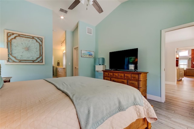 bedroom with high vaulted ceiling, ceiling fan, and light wood-type flooring