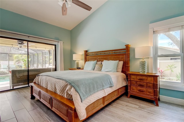 bedroom with access to exterior, light hardwood / wood-style flooring, high vaulted ceiling, and ceiling fan