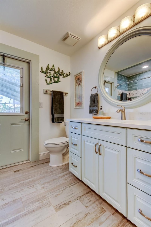 bathroom with vanity, walk in shower, and toilet