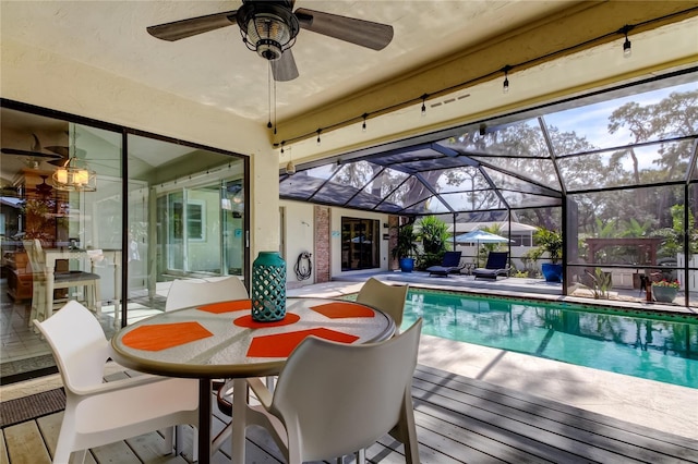 view of swimming pool with a lanai, a patio area, and ceiling fan