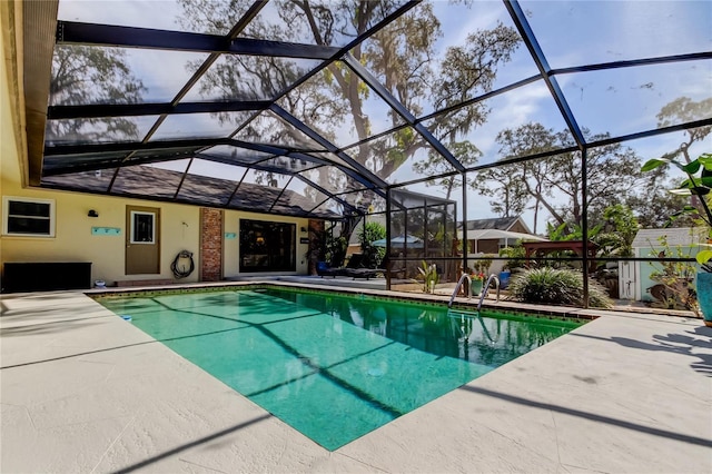 view of swimming pool featuring a patio area and glass enclosure