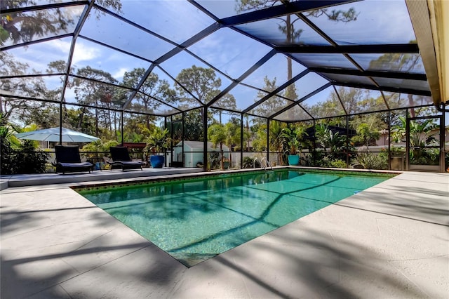 view of swimming pool featuring a patio, a shed, and glass enclosure