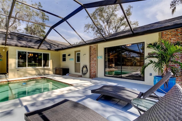 view of swimming pool with a lanai and a patio