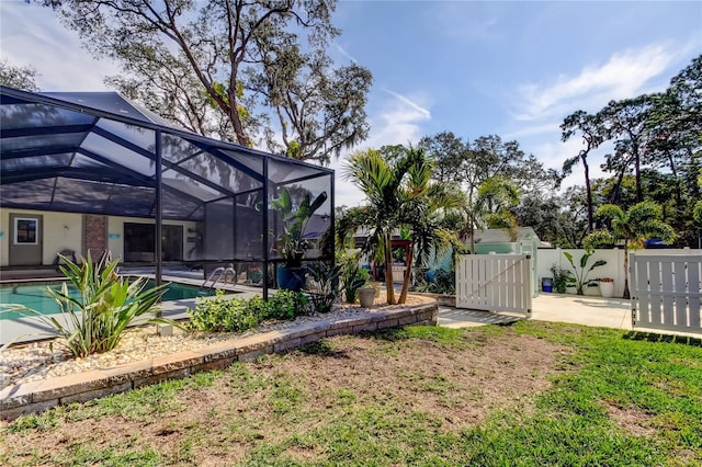 view of yard with a patio and glass enclosure