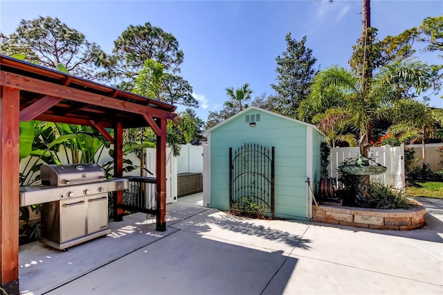 view of patio / terrace featuring a grill and a storage unit