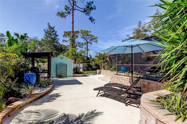 view of patio with a storage unit and a lanai