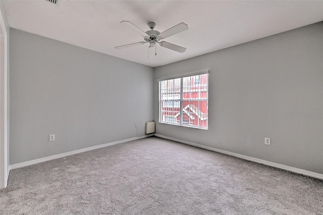 carpeted empty room with ceiling fan