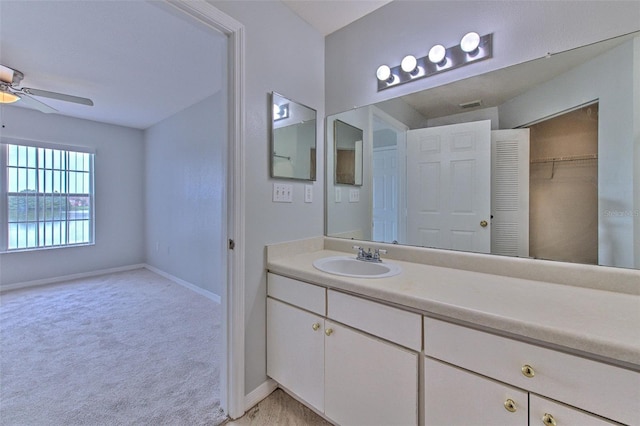 bathroom with ceiling fan and vanity