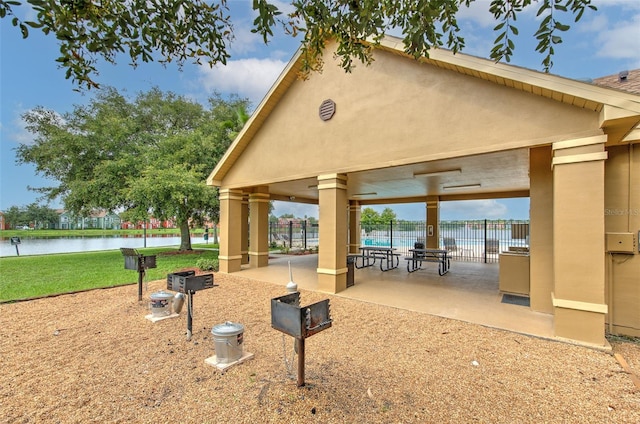 view of community with a patio and a water view