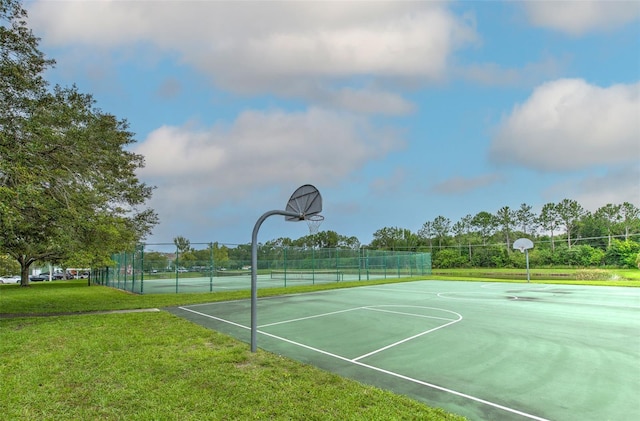 view of basketball court featuring a yard and tennis court