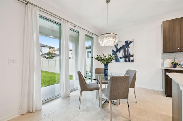 dining area featuring a chandelier, crown molding, and light tile patterned floors