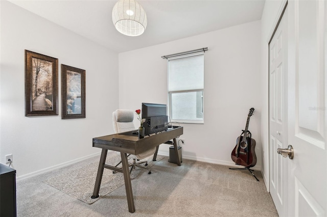 home office with baseboards and light colored carpet