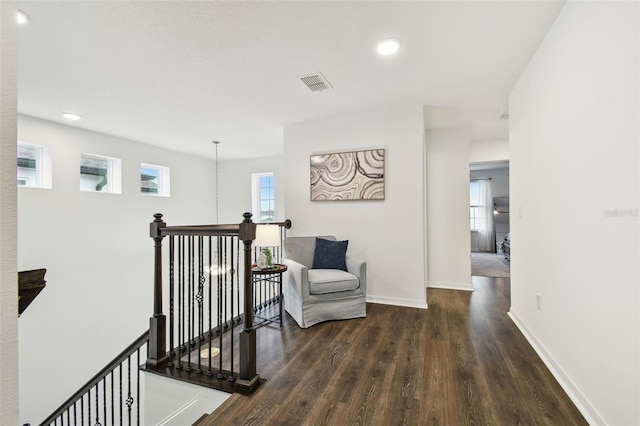 hall with baseboards, visible vents, wood finished floors, an upstairs landing, and recessed lighting