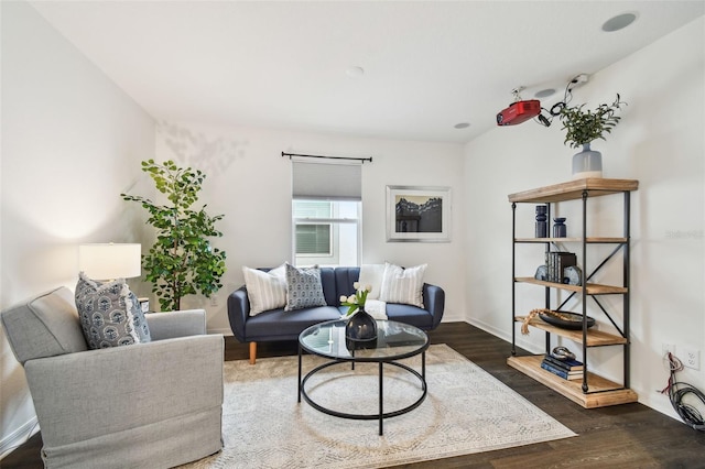 living area featuring wood finished floors and baseboards