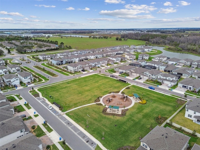 drone / aerial view with a water view and a residential view