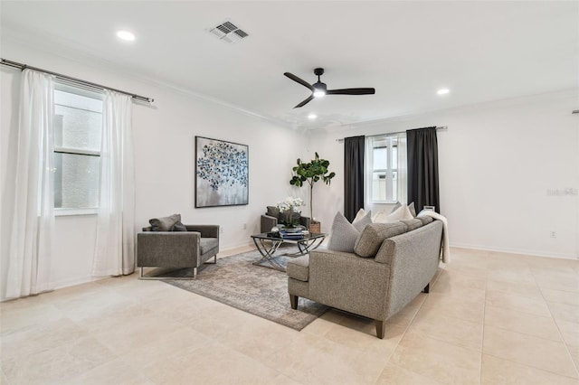 living room with crown molding, visible vents, ceiling fan, and baseboards