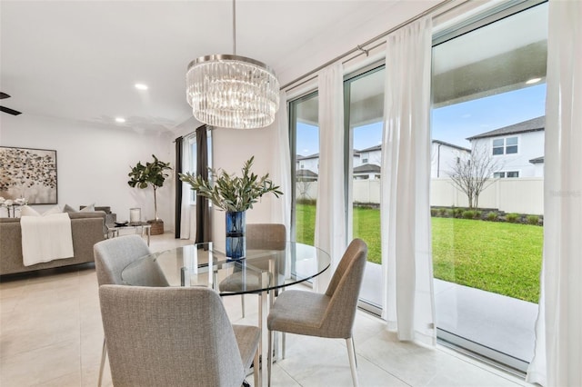 tiled dining space with an inviting chandelier and recessed lighting