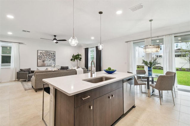 kitchen with a sink, visible vents, light countertops, and stainless steel dishwasher