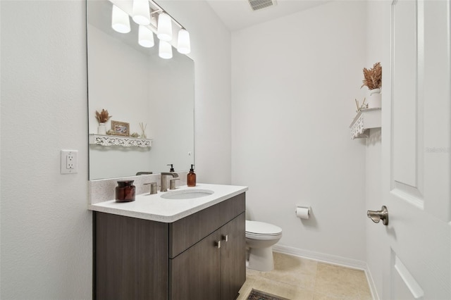 bathroom with vanity, toilet, and baseboards