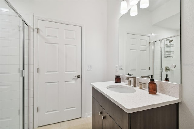 full bath with a stall shower, tile patterned flooring, and vanity