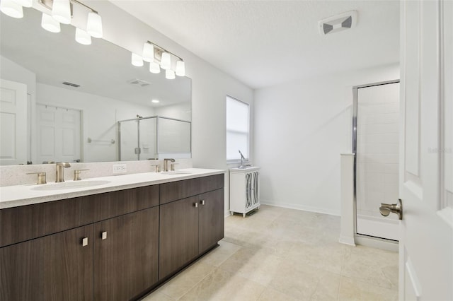 full bathroom with double vanity, a sink, visible vents, and a shower stall