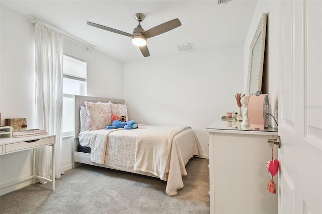 carpeted bedroom with ceiling fan, visible vents, and baseboards