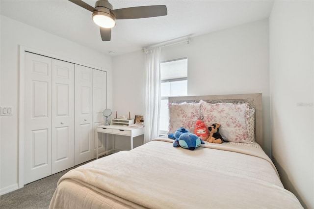 carpeted bedroom with a ceiling fan and a closet