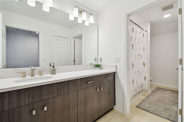 bathroom featuring visible vents, vanity, toilet, and tile patterned floors