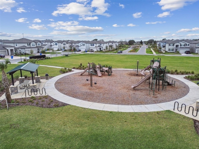 surrounding community with playground community, a lawn, and a residential view