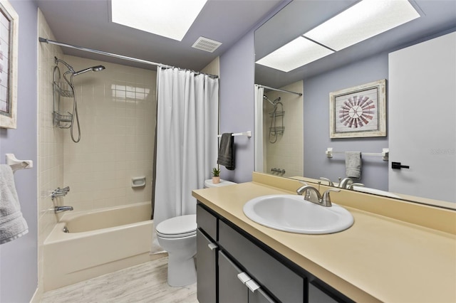 full bathroom with vanity, toilet, wood-type flooring, and shower / bath combo