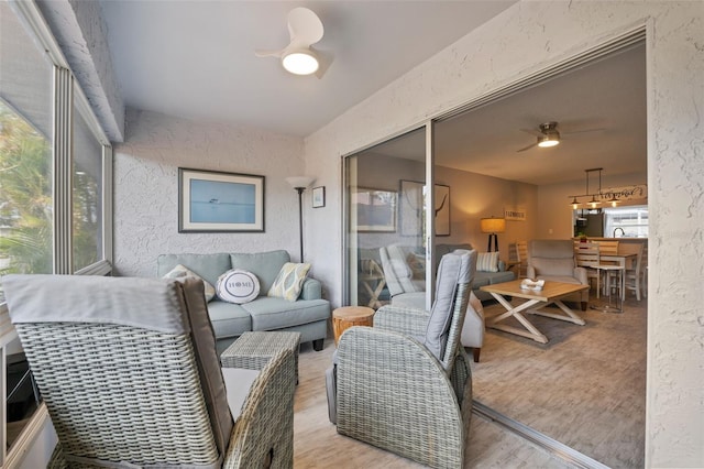 living room featuring ceiling fan and light hardwood / wood-style flooring