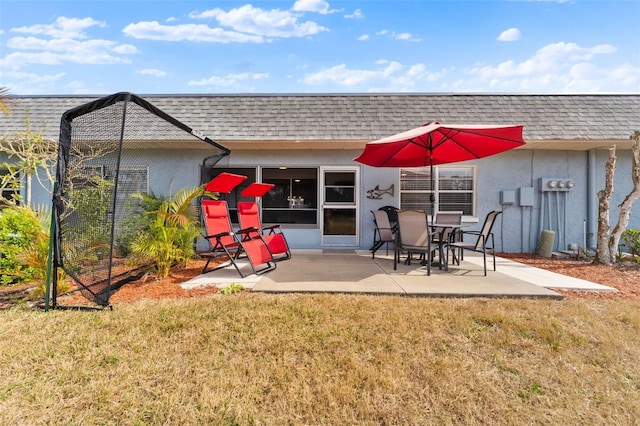 back of house featuring a patio and a lawn