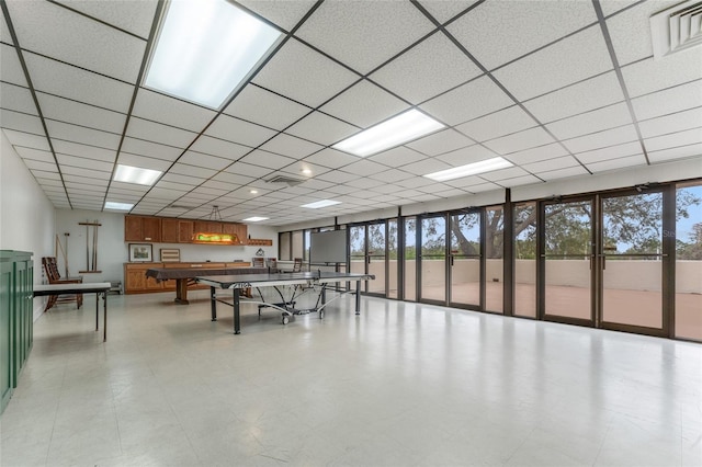 recreation room featuring plenty of natural light and a drop ceiling