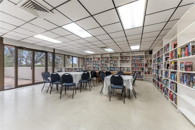 dining space with a drop ceiling