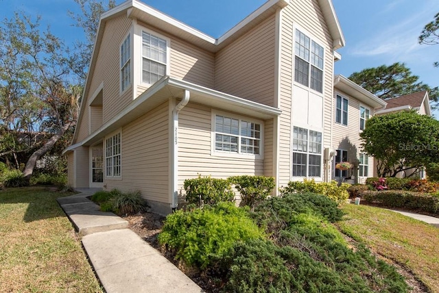 view of property exterior with a yard