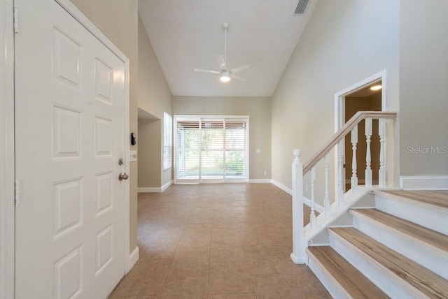 tiled foyer entrance featuring high vaulted ceiling and ceiling fan