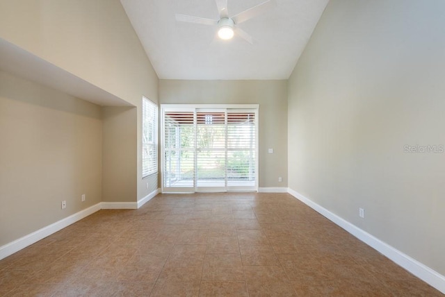 empty room featuring vaulted ceiling, light tile patterned floors, and ceiling fan