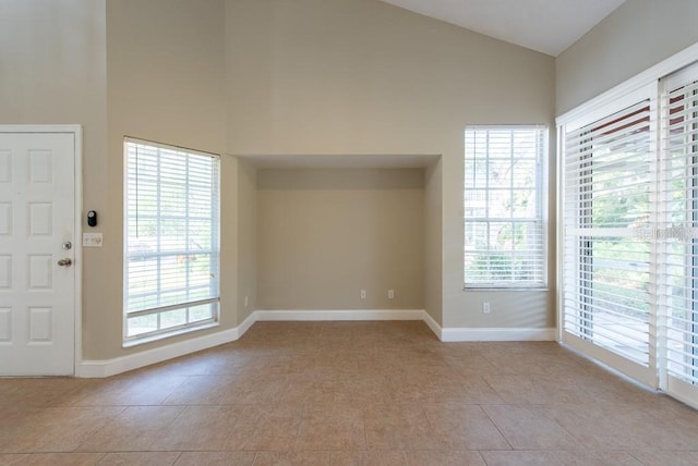 tiled foyer entrance with high vaulted ceiling