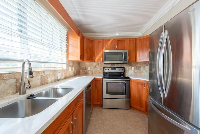 kitchen with light tile patterned flooring, sink, crown molding, stainless steel appliances, and backsplash