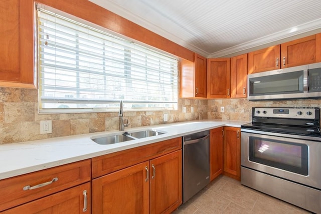 kitchen with sink, backsplash, light tile patterned floors, stainless steel appliances, and crown molding