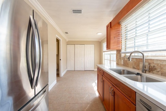 kitchen featuring light tile patterned flooring, sink, crown molding, stainless steel fridge, and dishwasher