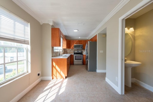 kitchen featuring sink, crown molding, light tile patterned floors, appliances with stainless steel finishes, and backsplash