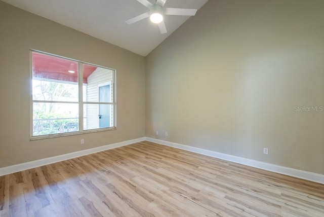 empty room with ceiling fan, lofted ceiling, and light hardwood / wood-style flooring