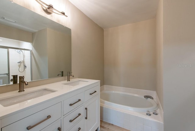 bathroom with vanity and independent shower and bath