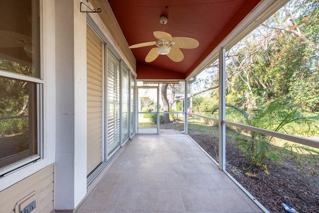 unfurnished sunroom featuring lofted ceiling and ceiling fan