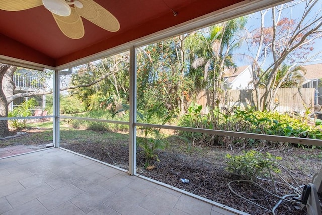 unfurnished sunroom featuring lofted ceiling and ceiling fan