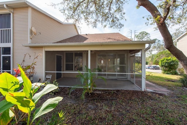 back of house featuring a patio area and a sunroom