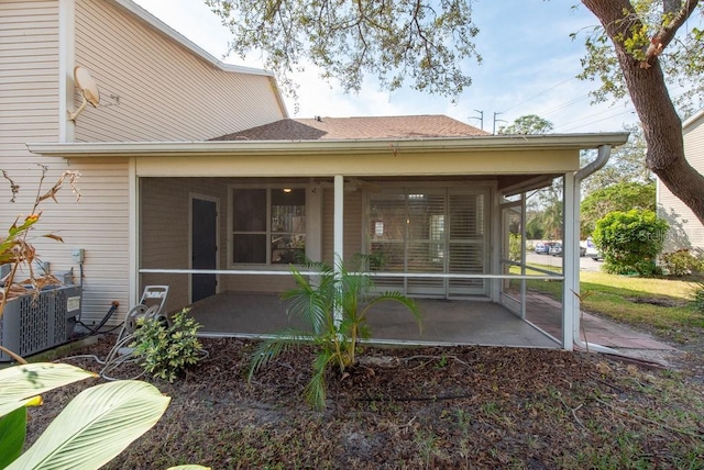 rear view of house with a sunroom, a patio, and central air condition unit