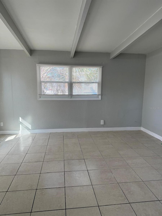 tiled spare room with plenty of natural light and beam ceiling