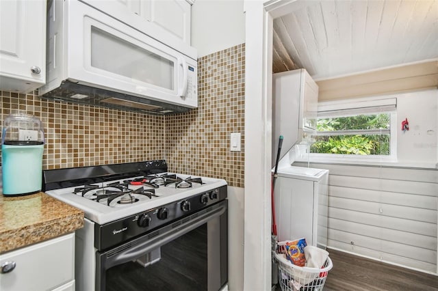 kitchen featuring dark hardwood / wood-style floors, tasteful backsplash, white cabinets, light stone counters, and white appliances